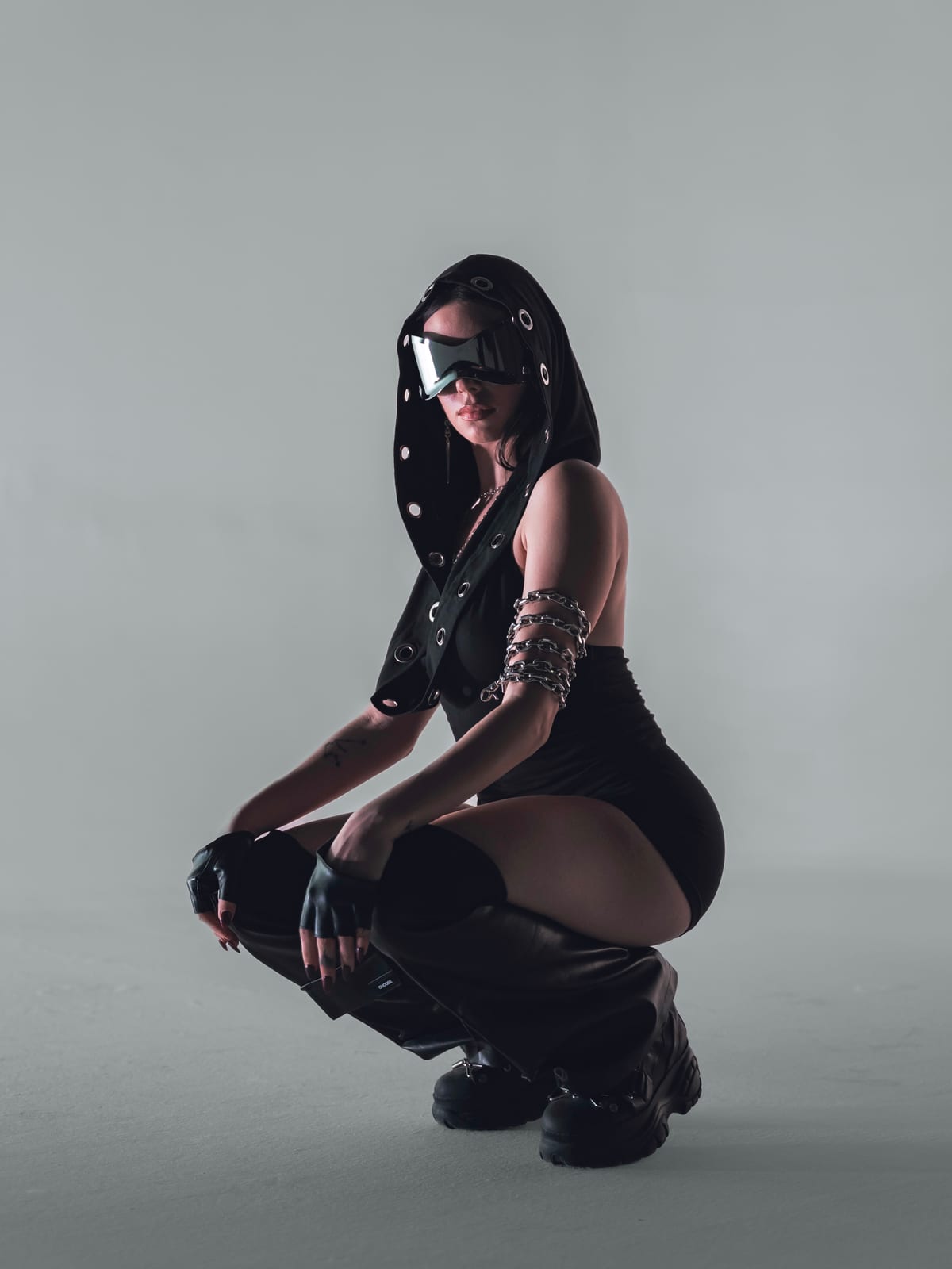 ELL3NI crouching in full look, studio portrait